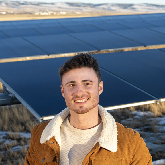 man in front of solar panels