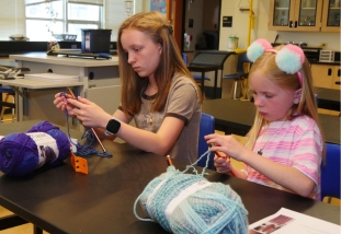two children knitting