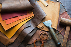 various colors of leather, a mallet and tools