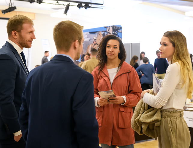 Two students meet with potential employers at a Career Fair hosted by the University of Wyoming