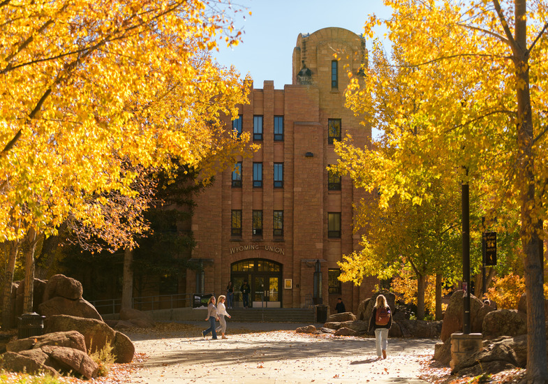 Wyoming Union entrance near Prexy's Pasture with fall trees