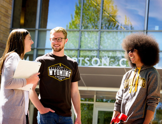 three students outside of Coe Library
