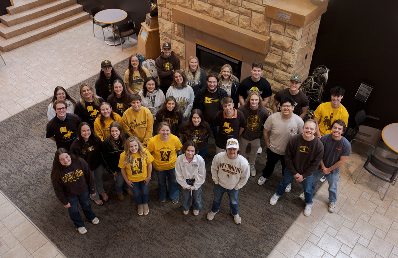 students stand in the union and look up at the camera