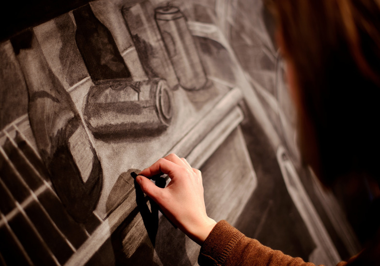 A student draws on a canvas