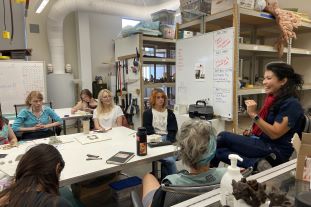 Artist talking to a classroom of students.
