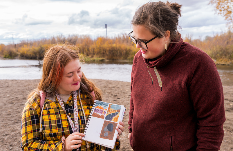 Art student consults with Visual Arts Professor on field trip.