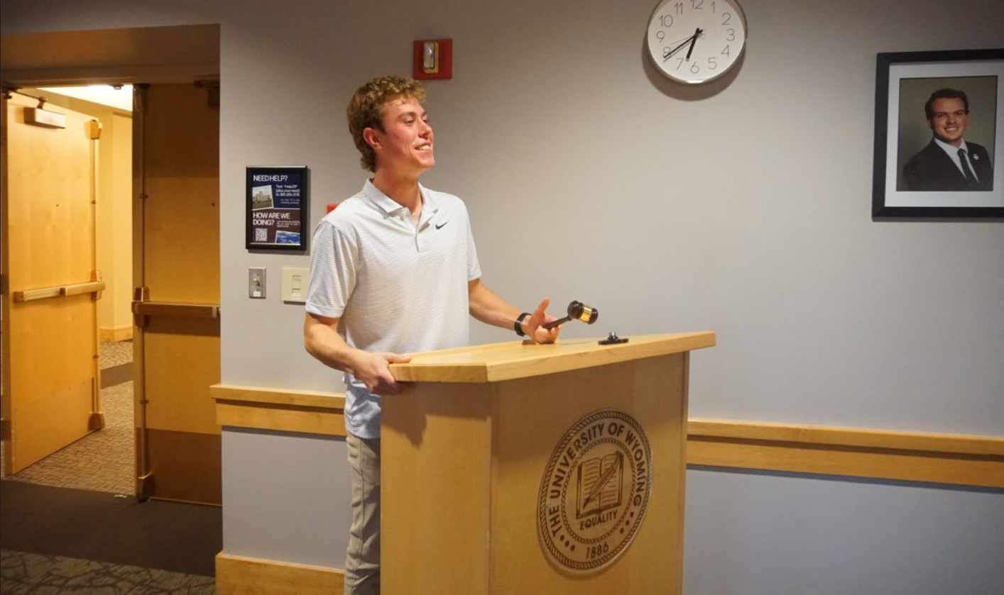 A group of UW students sit around a table and have a discussion