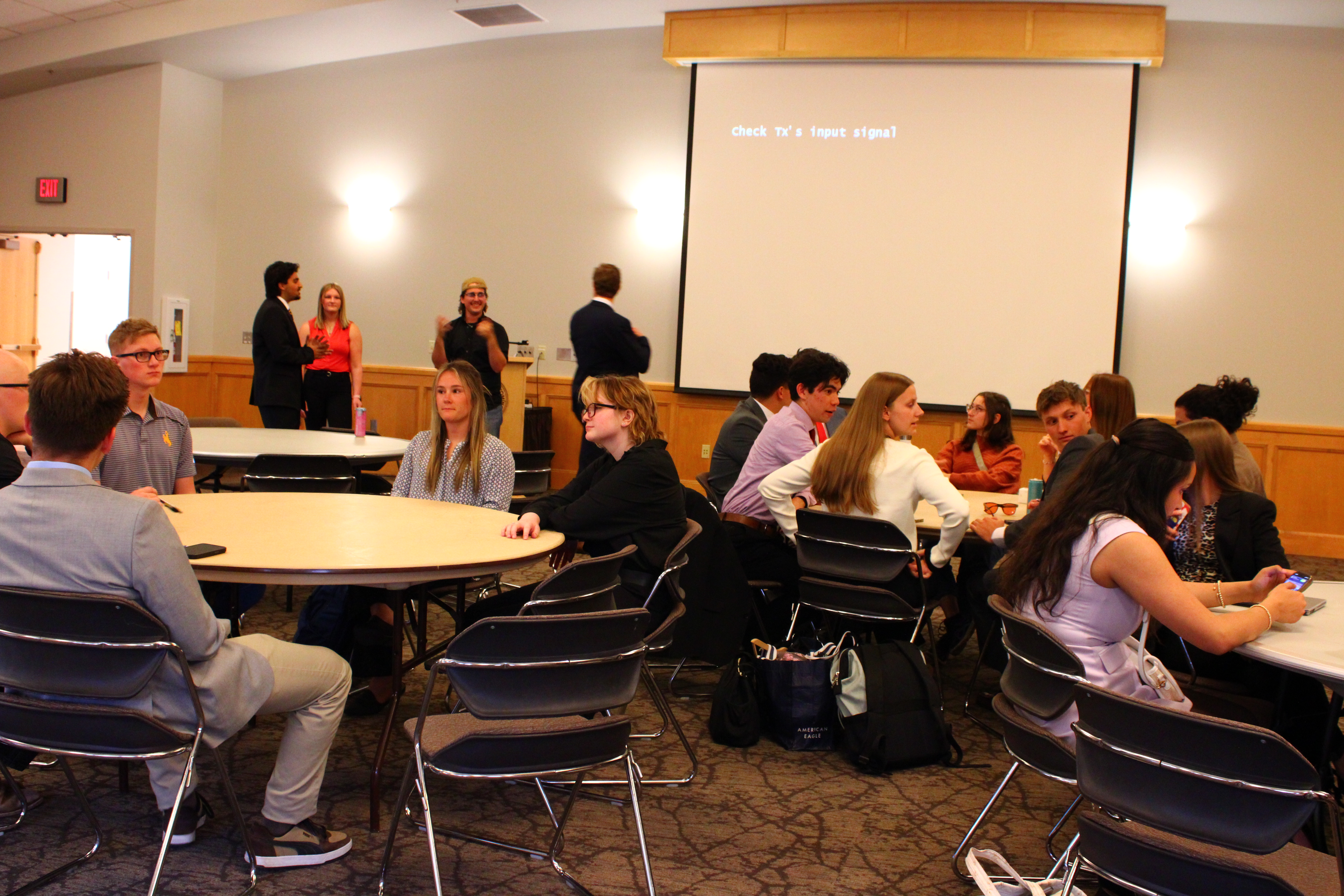A group of ASUW candidates attending a workshop and talking amongst themselves.