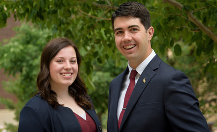 Two ASUW student government officials stand together and smile