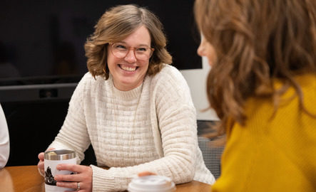 A UW staff member smiles during a work session with ASUW
