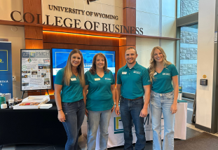 a group of employers smiles in the business breezeway