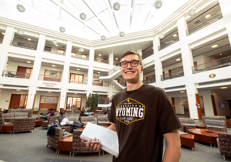 student in the College of Business atrium