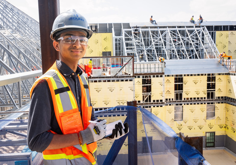 a student takes notes on a construction site