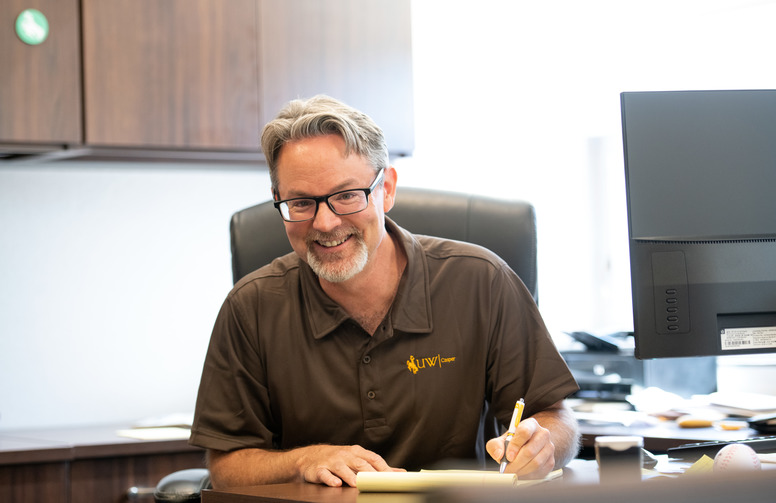 An academic advisor in a brown shirt.
