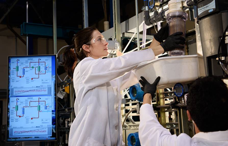 Savannah Bachman changes a water filter in the resources lab.