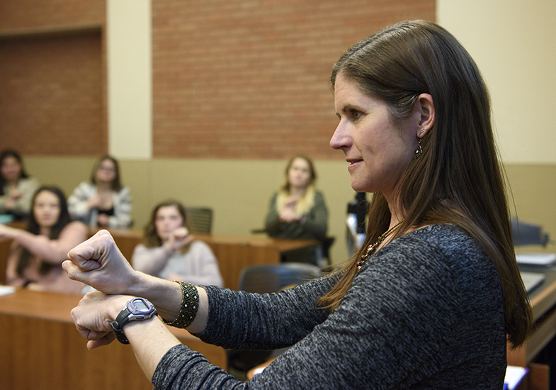 A female teacher signing in a classroom.