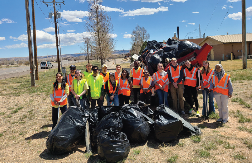A group picture of students at a trash pickup project