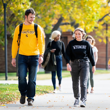 UW students walk outside on the University of Wyoming campus.