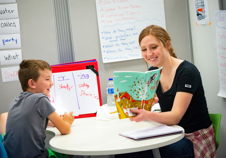 An education student reading to a student