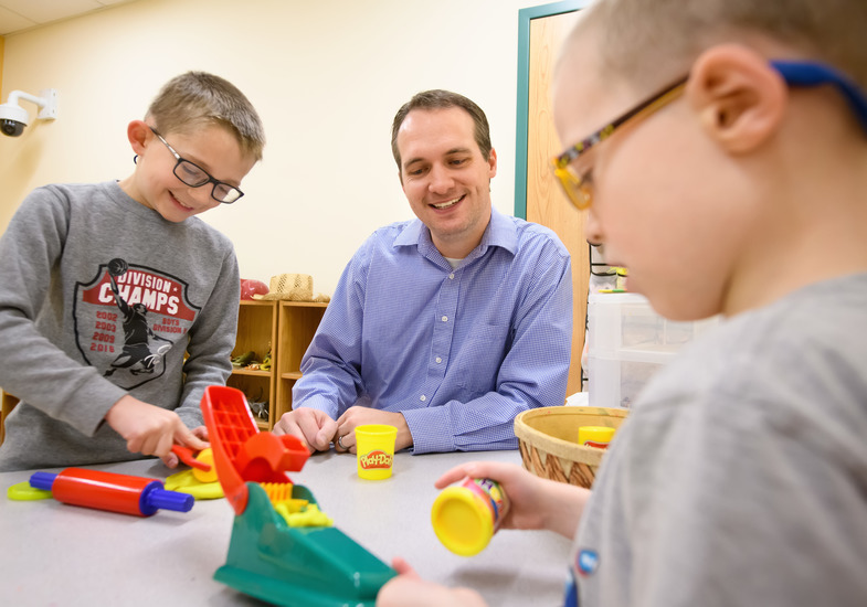 an student teacher working with children and blocks