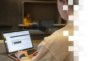 Student using laptop in Coe Library
