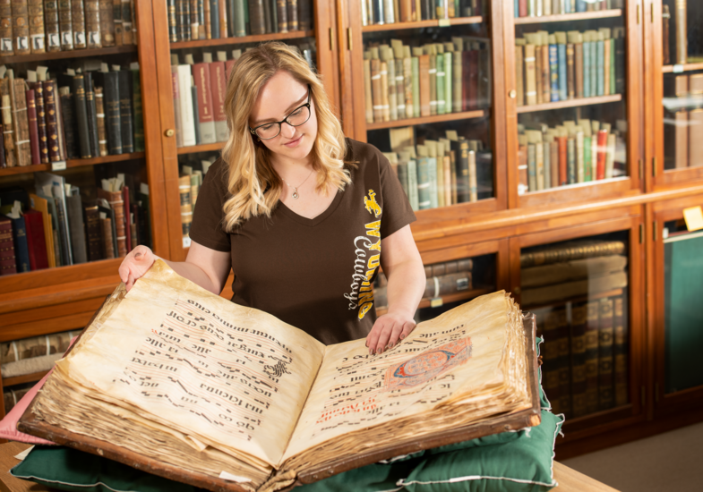 student reading a giant book