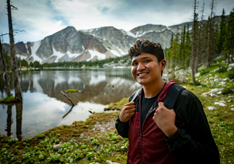 A UW student poses in front of a scenic view on a hike at a nearby outdoor recreation area.