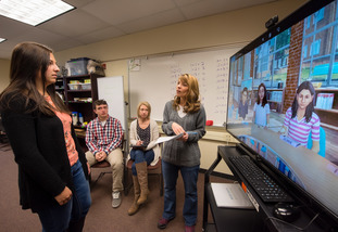 A professor teaching education students how to be teachers to K-12 students.