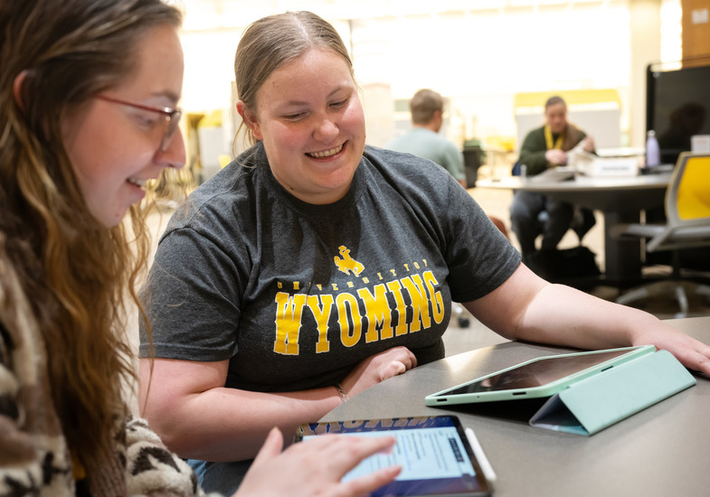 Two students work together on an iPad