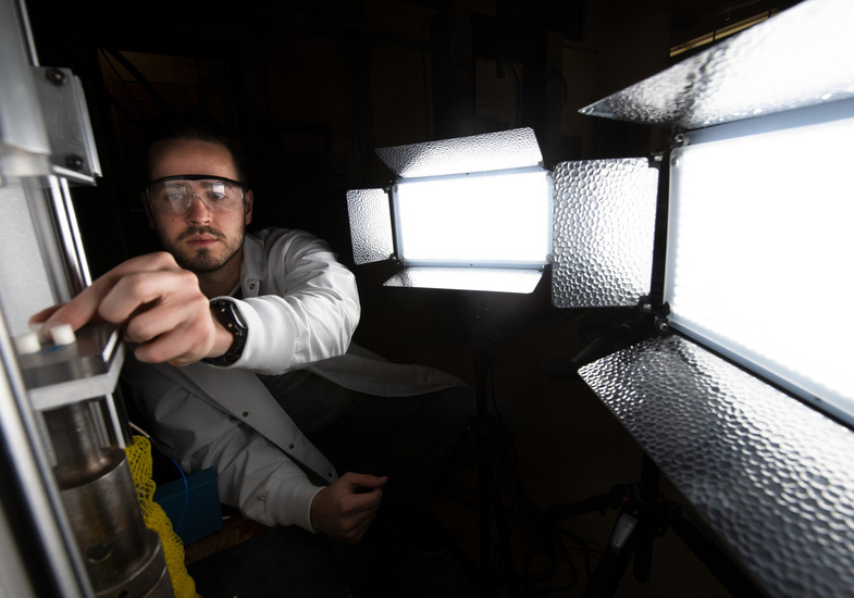 A mechanical engineering student works on a project in a lab