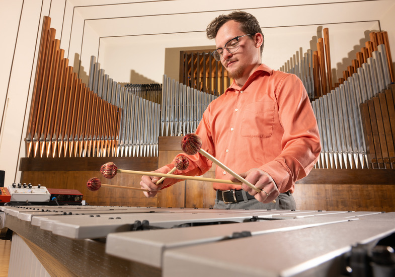 student plays thier instrument