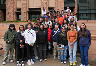 Group of students and mentors posing on stairs at the Native American Summer Institute