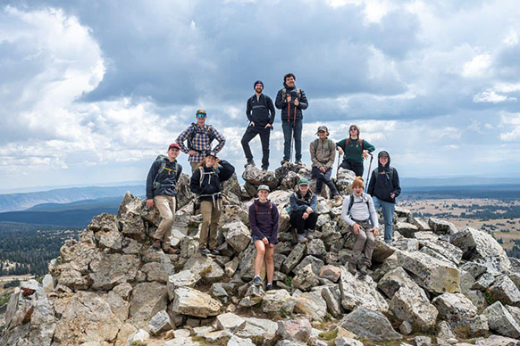hikers posing on a pile of rocks