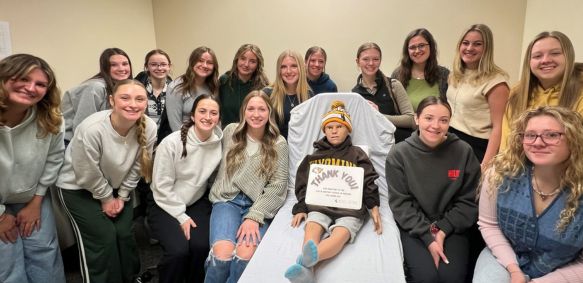 SNA students with peedie the clinical simulation manequin