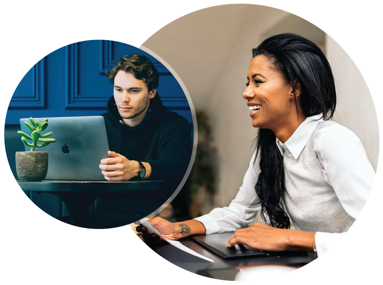Two students at laptops working and smiling