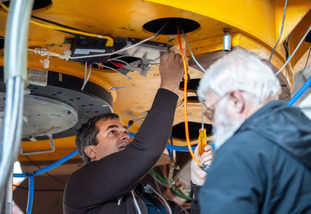 Two people work on an observatory together