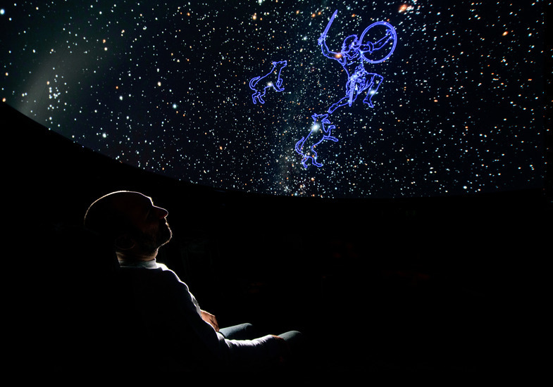 A person watches a show in the UW Planetarium