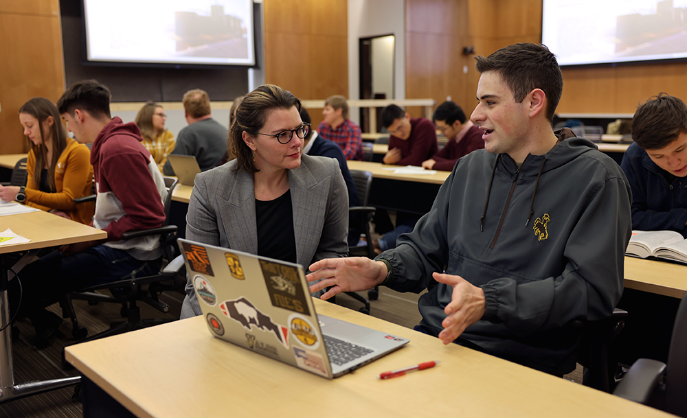 Professor and Student talking in a classroom