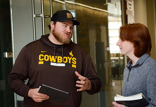 students speaking in hallway of EIC