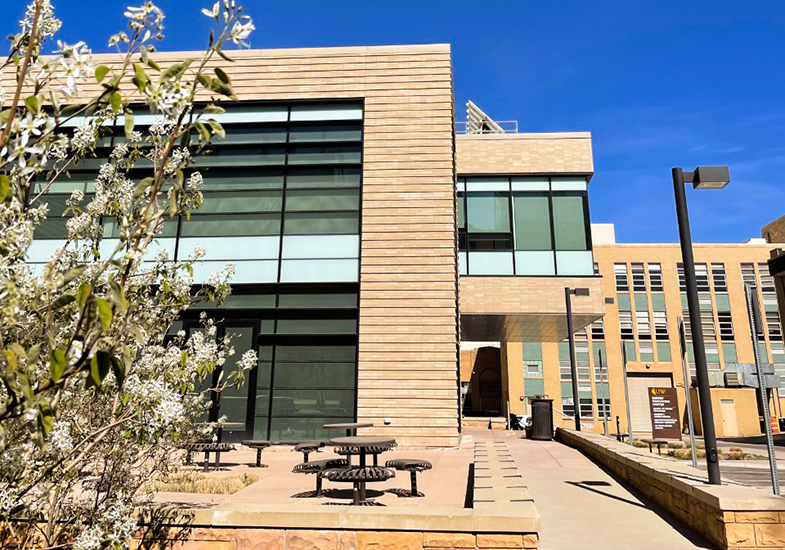 The Energy Innovation Center building with crab apple blossoms in the foreground
