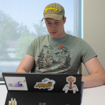 Student studies with laptop.