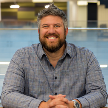 A researcher smiles for a photo