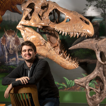 A student smiles for a photo in the Geological Museum