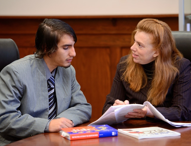 Dr. Stephanie Anderson meeting with a student dressed in professional attire