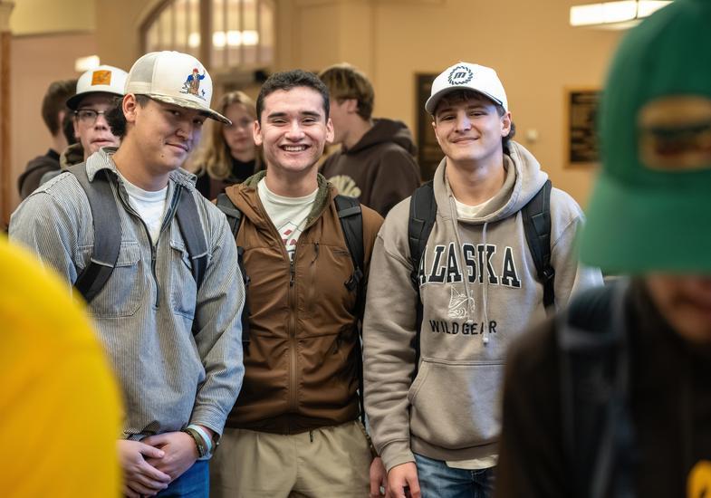 Three students pose for a photo at event