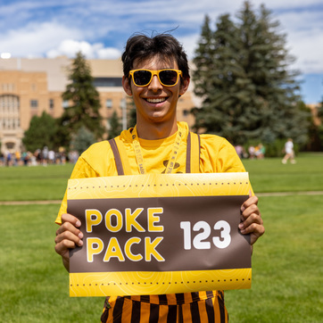 A UW Western Thunder member smiles broadly as they march in a UW event.