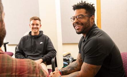 UW students and counselors from the University Counseling Center have a discussion during a group session.