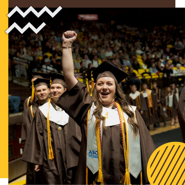 A student fist pumps after graduation