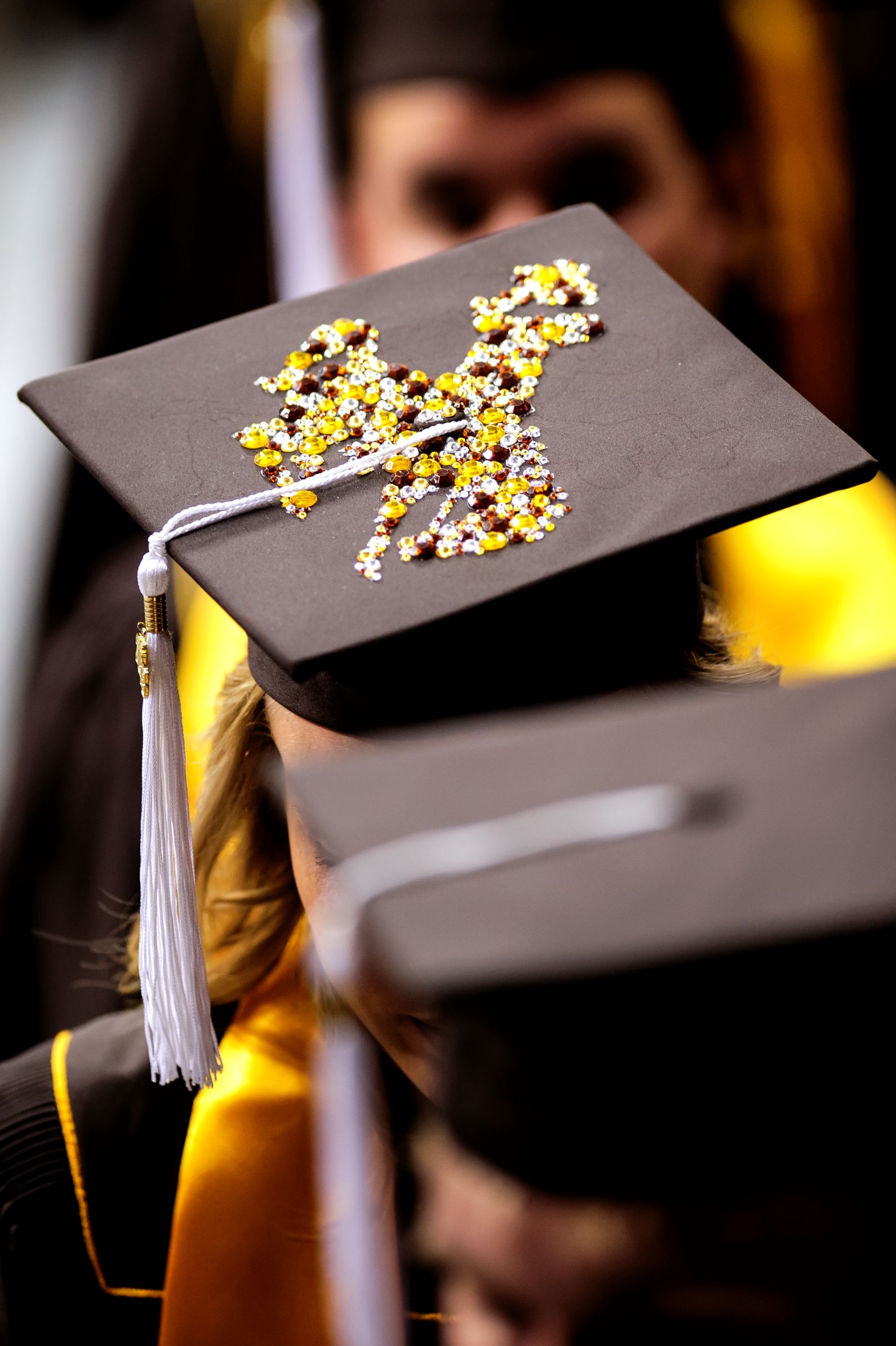 A graduation mortar board with a jeweled bucking horse icons design