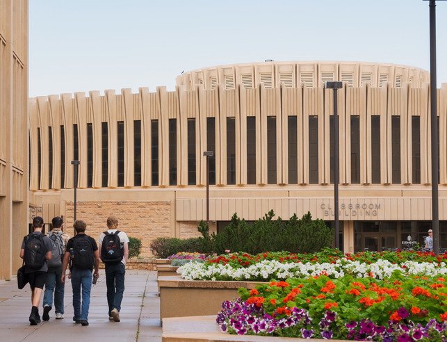 Students walk together to class in front of UW's classroom building.